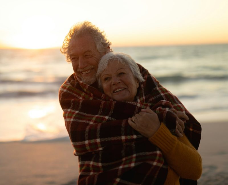 Old couple in love at the beach